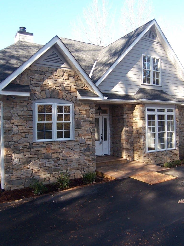 Stone exterior home with gabled roof in Weaverville